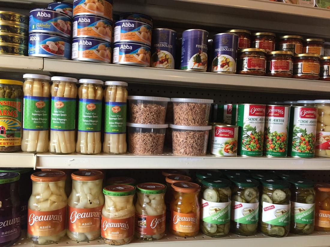Jars of Beauvais r&oslash;dk&aring;l, asier and agurkesalat with Abba tins at Hansel Deli in Surrey BC