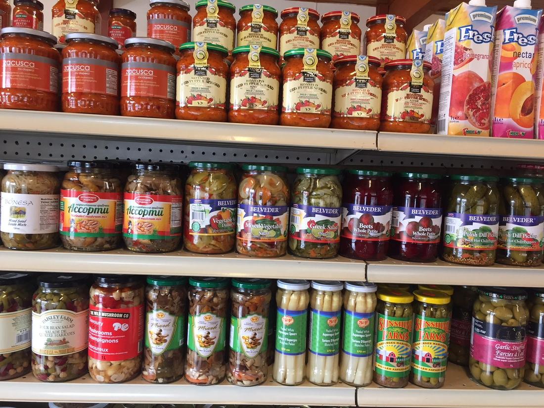 Shelves of zacusca, ajvar, Belveder Polish pickles and pickled vegetables at Hansel Deli in Surrey BC
